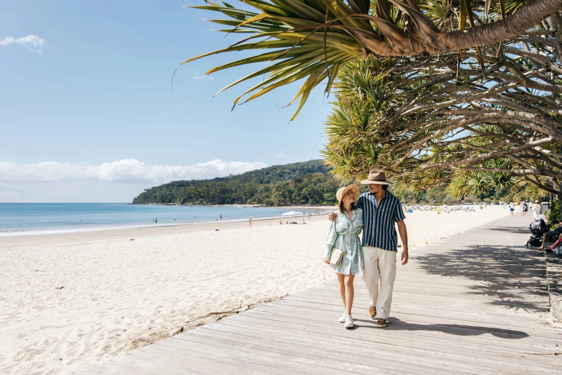 Couple walking together along a sunny beach