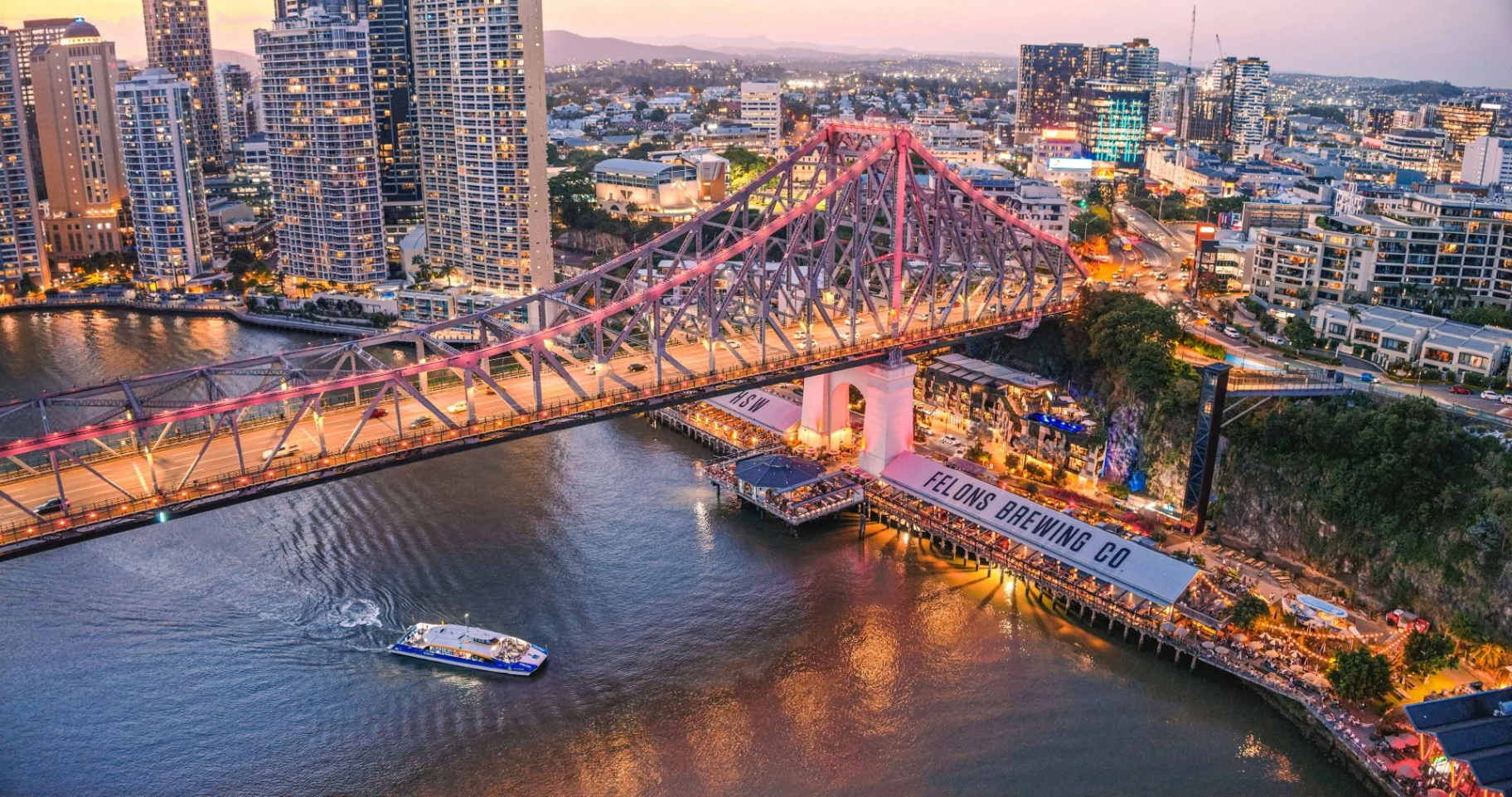 Aerial view of Story Bridge and the riverside at Howard Smith Wharves at dusk