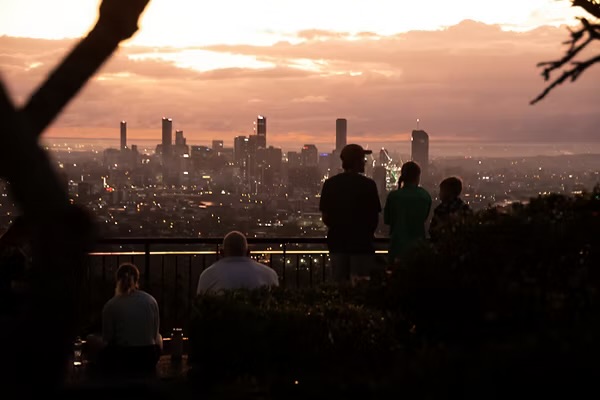 Brisbane skyline beneath a vivid sunset from Mt Coot-tha lookout